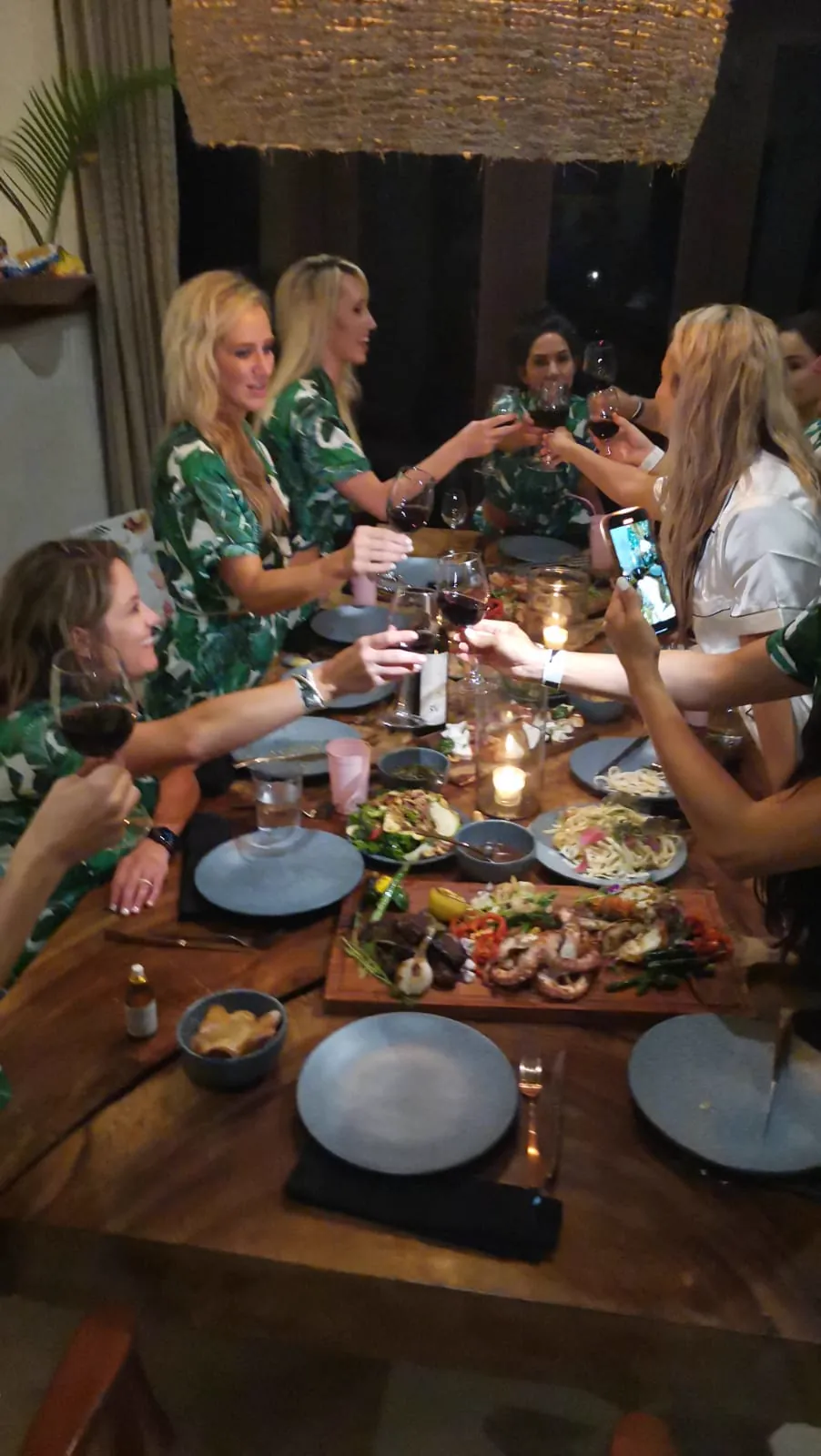 Guests raising glasses around a villa dinner table